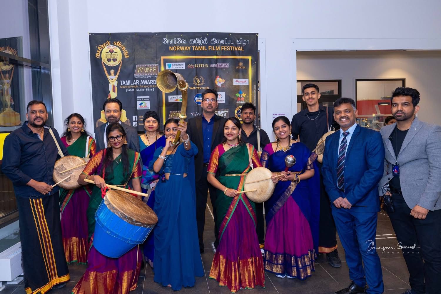 Tamil Arts UK performers with drums in front of the Norway Tamil Film Festival banner