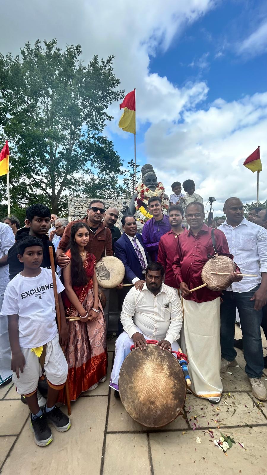 Community group photo with drummers at an outdoor Tamil Arts UK event